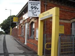 The station entrances with the stairs entrance to the platform for trams to Altrincham in the foreground