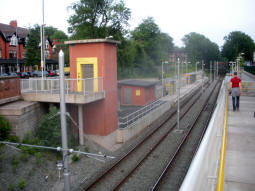 A view of the platform for trams to East Didsbury and the lift to it from the ramp towards the other platform